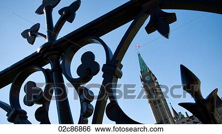 Stock Photograph - Canadian Cities, Canada's Peace Tower through Parliament's iron gate, Ottawa.. Fotosearch