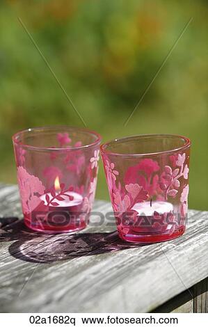 Stock Photography - Candles in pink glasses. Fotosearch