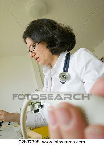 Cardiologist examines the heart with ultrasound machine View Large Photo Image Stock Photo - Cardiologist examines the heart with ultrasound machine. Fotosearch