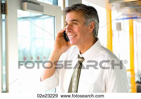Casually dressed businessman talking on cellular PDA. View Large Photo Image Stock Photo - Casually dressed businessman talking on cellular PDA.. Fotosearch