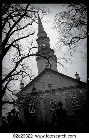 Catholic church behind dark tree branches. View Large Photo Image Stock Image - Catholic church behind dark tree branches.. Fotosearch