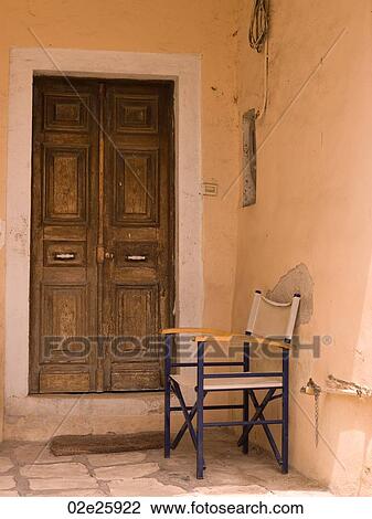 Chair outside doorway in Corfu View Large Photo Image Stock Image - Chair outside doorway in Corfu. Fotosearch