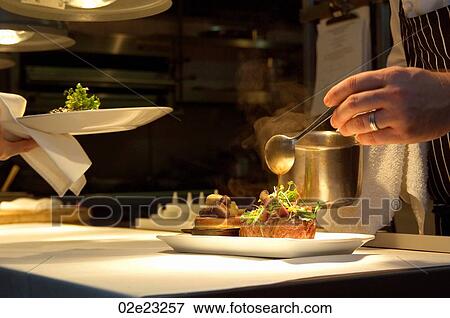 Chef putting final touches on gourmet meal. View Large Photo Image Stock Photo - Chef putting final touches on gourmet meal.. Fotosearch