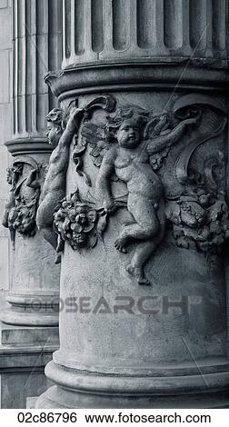 Stock Photograph - Cherub detail on old architectural pillar.. Fotosearch