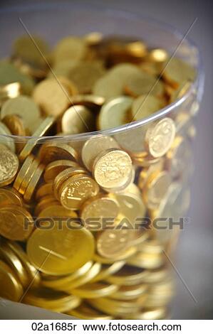 Stock Photography - Chocolate coins in a jar. Fotosearch