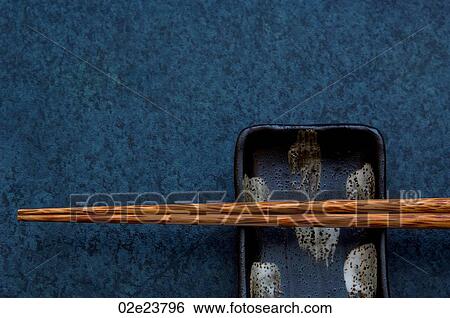 Chopsticks resting on small asian dish. View Large Photo Image Stock Photograph - Chopsticks resting on small asian dish.. Fotosearch