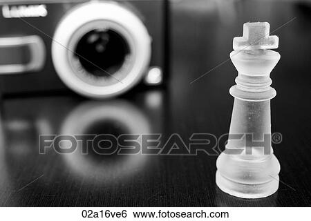 Clear chess piece and stereo speaker reflected in wooden tabletop View Large Photo Image Stock Photograph - Clear chess piece and stereo speaker reflected in wooden tabletop. Fotosearch