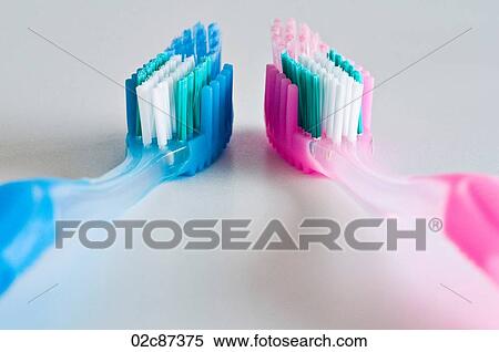 Close up of a couple of pink and blue toothbrushes face-up and side by side. View Large Photo Image Stock Photography - Close up of a couple of pink and blue toothbrushes face-up and side by side.. Fotosearch