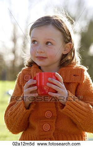 Close-up of a girl holding a coffee cup View Large Photo Image Stock Image - Close-up of a girl holding a coffee cup. Fotosearch