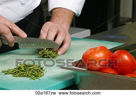 Close up of a person chopping vegetables View Large Photo Image Stock Photo - Close up of a person chopping vegetables. Fotosearch