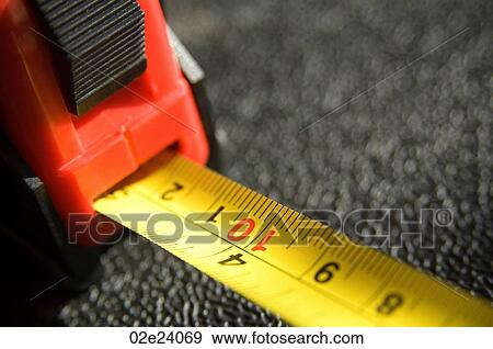 Stock Photo - Close-up of a red and yellow tape measure.. Fotosearch