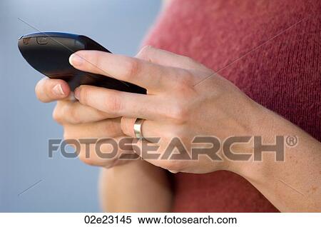 Close-up of a women's hands using a cellular PDA. View Large Photo Image Stock Photography - Close-up of a women's hands using a cellular PDA.. Fotosearch