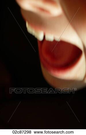Stock Photo - Close up of child with open mouth screaming.. Fotosearch