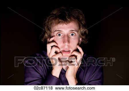 Close-up of frightened man with mysterious lighting. View Large Photo Image Stock Photo - Close-up of frightened man with mysterious lighting.. Fotosearch