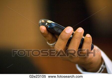 Close-up of hand with cellular PDA. View Large Photo Image Stock Photography - Close-up of hand with cellular PDA.. Fotosearch