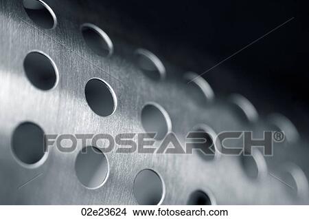 Close-up of shiney cylinder with holes. View Large Photo Image Picture - Close-up of shiney cylinder with holes.. Fotosearch