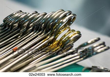 Stock Image - Close-up of surgical scissor clamps in operating room.. Fotosearch