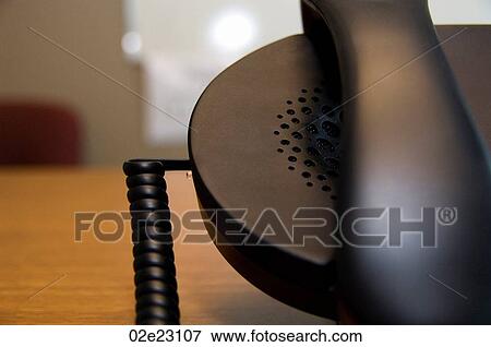 Close-up of telephone on office desk. View Large Photo Image Stock Photo - Close-up of telephone on office desk.. Fotosearch