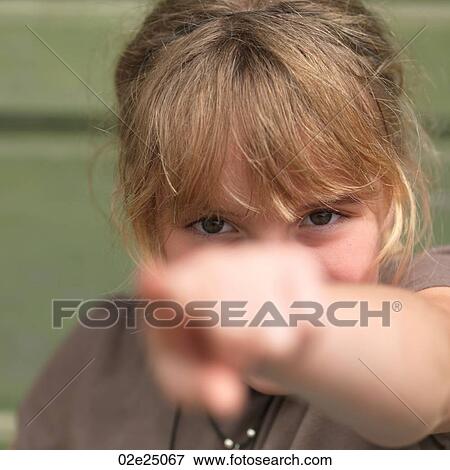 Close up of young girl pointing. View Large Photo Image Stock Photo - Close up of young girl pointing. . Fotosearch