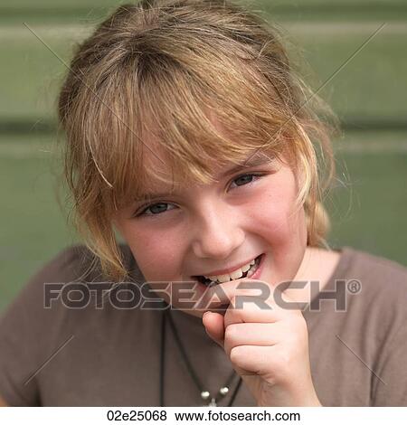 Stock Photo - Close up of young girl smiling. . Fotosearch