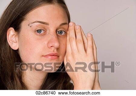 Close-up portrait of beautiful young woman with hands to face. View Large Photo Image Stock Image - Close-up portrait of beautiful young woman with hands to face.. Fotosearch