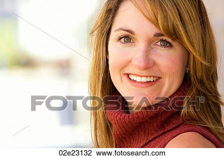 Stock Image - Close-up portrait of young smiling woman.. Fotosearch