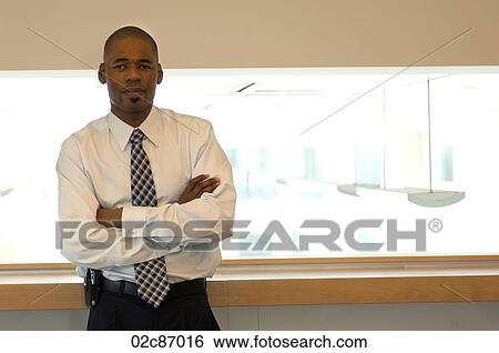 Stock Photograph - Confident African-American businessman with arms folded.. Fotosearch