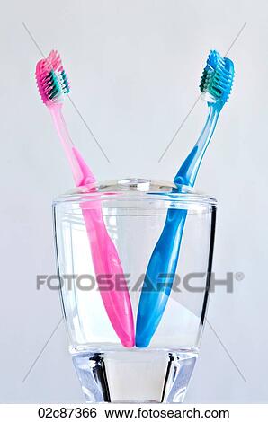 Couple of pink and blue toothbrushes in toothbrush holder. View Large Photo Image Stock Photograph - Couple of pink and blue toothbrushes in toothbrush holder.. Fotosearch