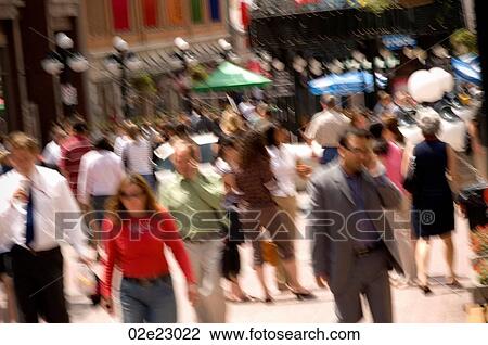 Stock Image - Crowded downtown sidewalk in the summer.. Fotosearch