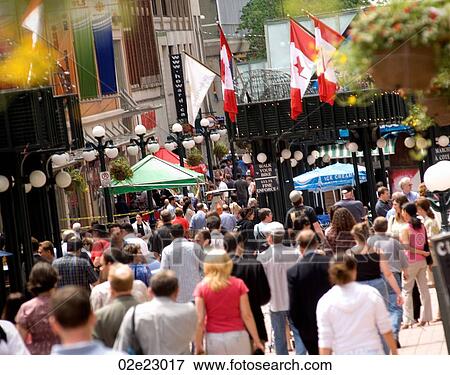 Crowded downtown sidewalk in the summer. View Large Photo Image Stock Photo - Crowded downtown sidewalk in the summer.. Fotosearch