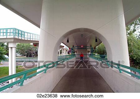 Cyclist crossing bridge in Calgary Canada. View Large Photo Image Stock Photo - Cyclist crossing bridge in Calgary Canada.. Fotosearch