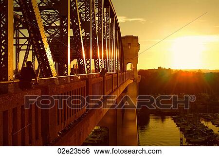 Cylcling commuter crossing Burrard bridge into the sunset, Vancouver Canada. View Large Photo Image Stock Photograph - Cylcling commuter crossing Burrard bridge into the sunset, Vancouver Canada.. Fotosearch