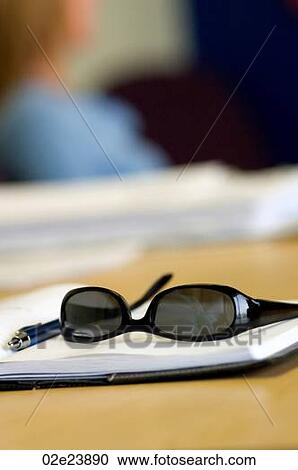 Dark sunglasses on office day-timer. View Large Photo Image Stock Image - Dark sunglasses on office day-timer.. Fotosearch