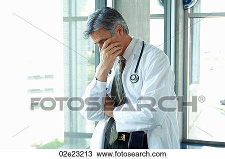 Doctor having a personal moment of sadness. View Large Photo Image Stock Image - Doctor having a personal moment of sadness.. Fotosearch