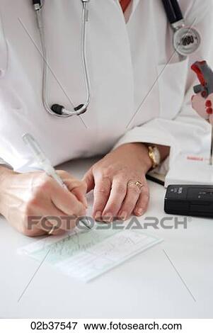 Doctor writing a prescription View Large Photo Image Stock Photo - Doctor writing a prescription. Fotosearch