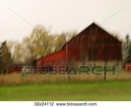 Stock Image - Driving past old rural red barn.. Fotosearch