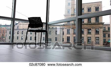Empty chair sitting in-front of window. View Large Photo Image Stock Image - Empty chair sitting in-front of window.. Fotosearch