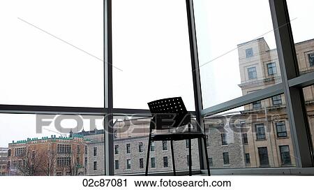 Empty chair sitting in-front of window. View Large Photo Image Stock Image - Empty chair sitting in-front of window.. Fotosearch