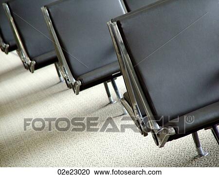 Stock Image - Empty seats in airport waiting lounge.. Fotosearch