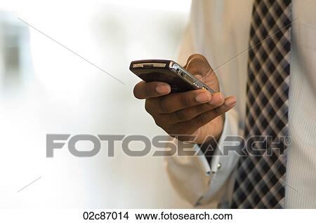 Executive using Blackberry PDA smart phone. View Large Photo Image Picture - Executive using Blackberry PDA smart phone.. Fotosearch