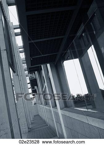 Stock Photo - Exterior of building corridor with windows and pillars.. Fotosearch