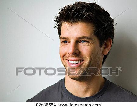 Face shot of a young smiling man. View Large Photo Image Picture - Face shot of a young smiling man.. Fotosearch