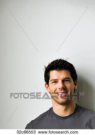 Stock Image - Face shot of a young smiling man.. Fotosearch