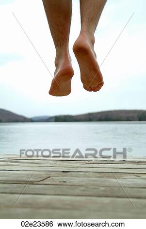 Feet jumping of cottage dock into water. View Large Photo Image Stock Photograph - Feet jumping of cottage dock into water.. Fotosearch