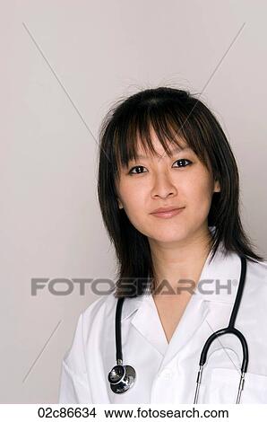 Female Asian doctor with lab coat and stethoscope View Large Photo Image Picture - Female Asian doctor with lab coat and stethoscope. Fotosearch