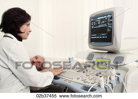 Female cardiologist operates machine View Large Photo Image Stock Photography - Female cardiologist operates machine. Fotosearch