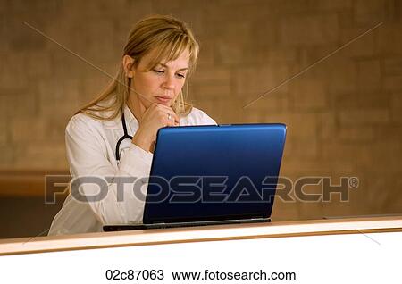 Female doctor with laptop in hospital. View Large Photo Image Stock Image - Female doctor with laptop in hospital.. Fotosearch