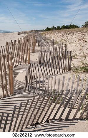 Stock Image - Fencing along the beach at the Hamptons. Fotosearch