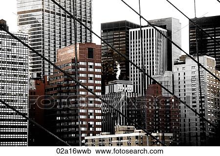 Stock Image - Financial district of New York viewed from Brooklyn Bridge. Fotosearch