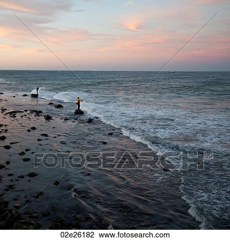 Stock Image - Fisherman on the Hamptons seashore. Fotosearch